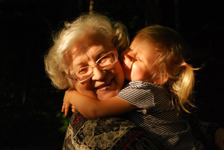 grandmother and granddaughter embrace